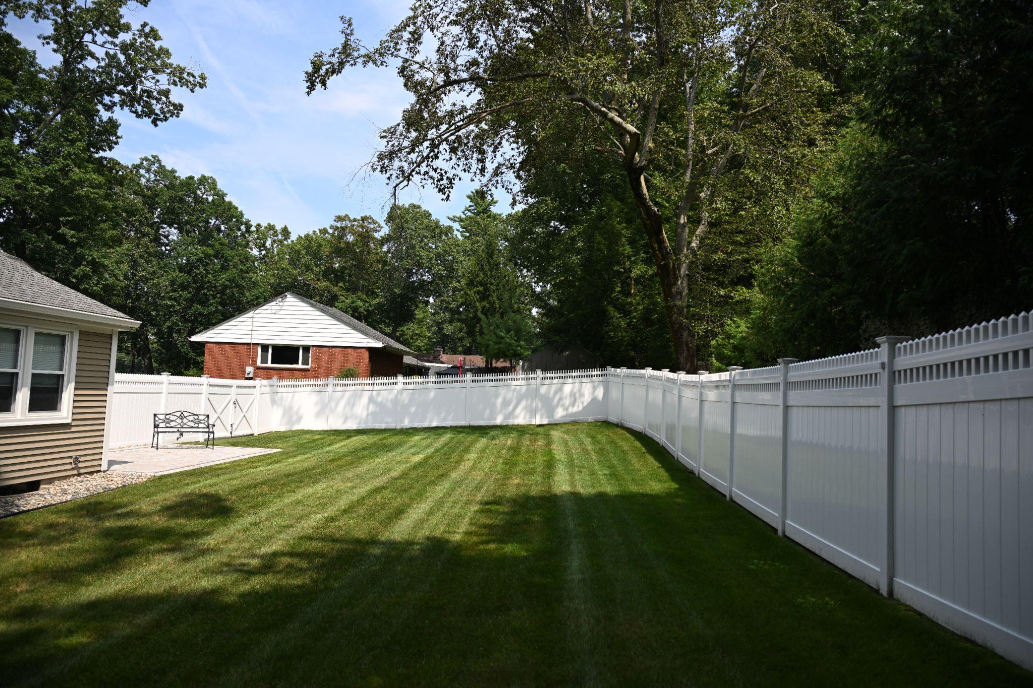 A white fence and a house.