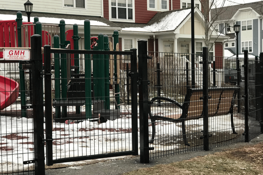 Black metal wire fence and swing gate installed around playground for safety in West Hartford Connecticut