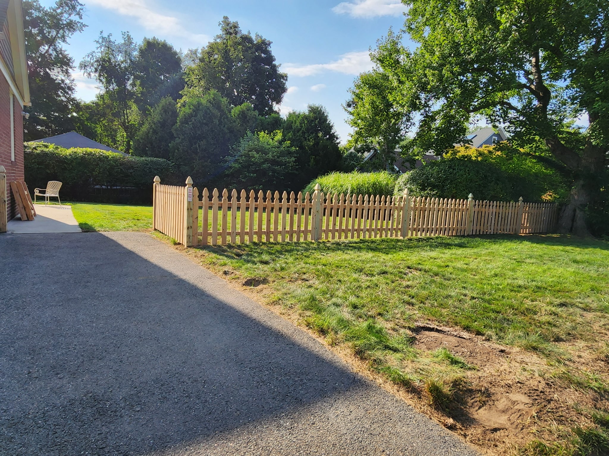 Four-foot cedar spaced picket fence with a matching gate installed along a landscaped residential yard in Longmeadow, MA.